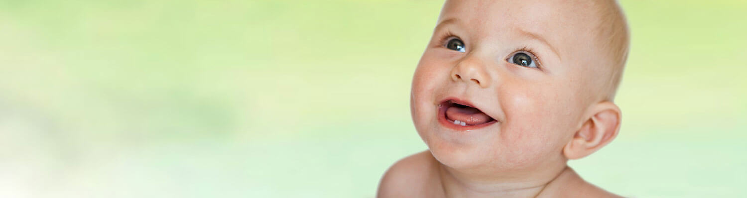 A baby with a wide-open mouth and a curious expression.