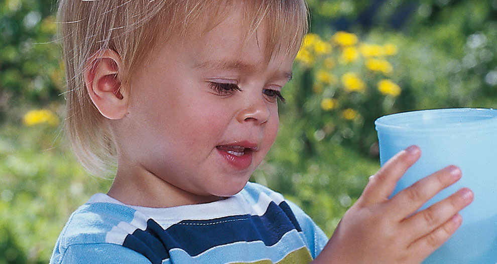 Child drinking from a cup.